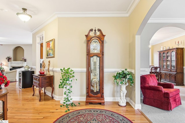 entrance foyer with crown molding and hardwood / wood-style floors