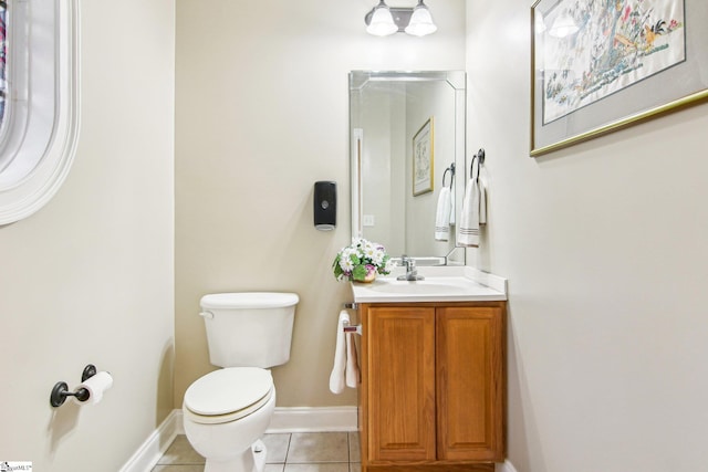 bathroom featuring vanity, tile patterned floors, and toilet