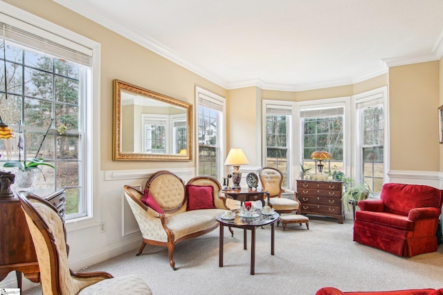 living area with plenty of natural light, ornamental molding, and carpet