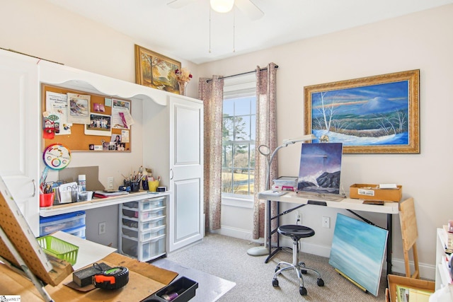 office area with ceiling fan, a healthy amount of sunlight, and light carpet