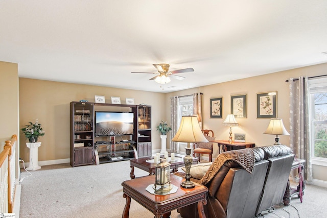 carpeted living room featuring plenty of natural light and ceiling fan