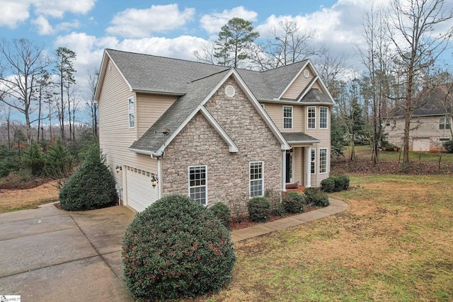 view of front of home featuring a garage and a front yard