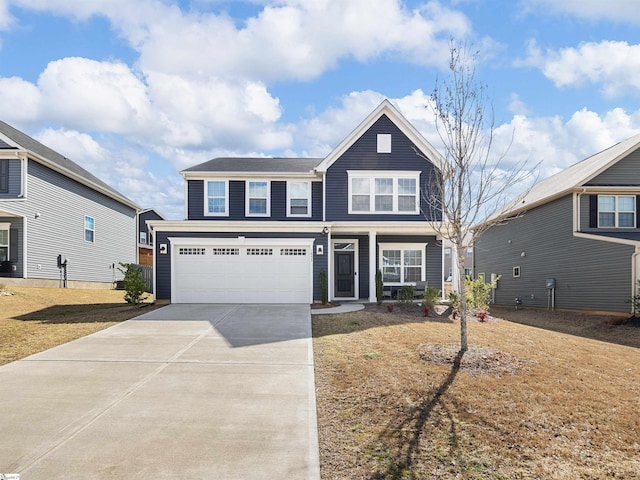 view of front of property with a garage and a front lawn