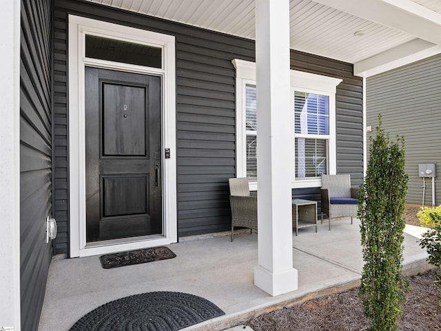 view of exterior entry with covered porch