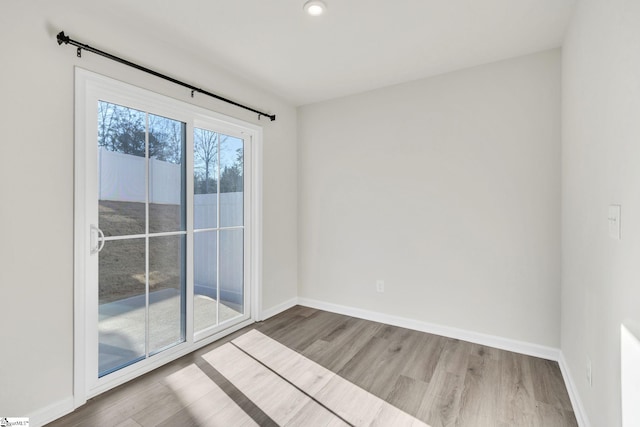 spare room with light wood-type flooring