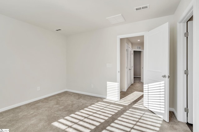 unfurnished room featuring light colored carpet