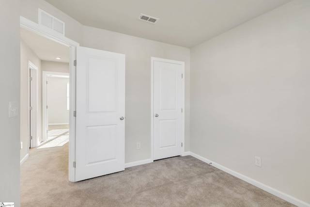 unfurnished bedroom featuring light colored carpet