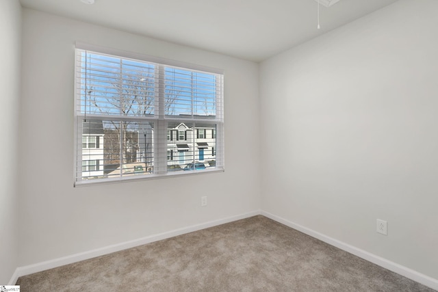 spare room featuring light carpet and a wealth of natural light