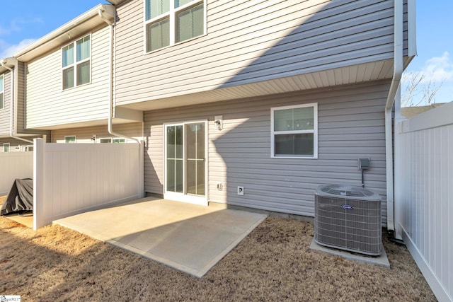 back of property with a patio and central air condition unit