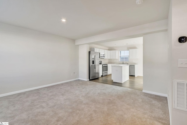 unfurnished living room featuring carpet flooring