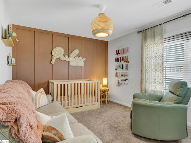 carpeted bedroom with a crib