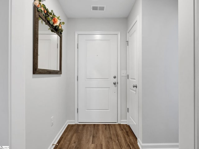 doorway to outside with dark wood-type flooring