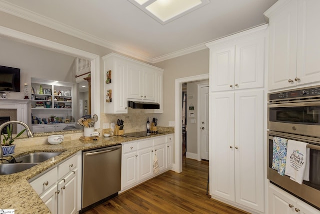 kitchen featuring sink, light stone countertops, white cabinets, and appliances with stainless steel finishes