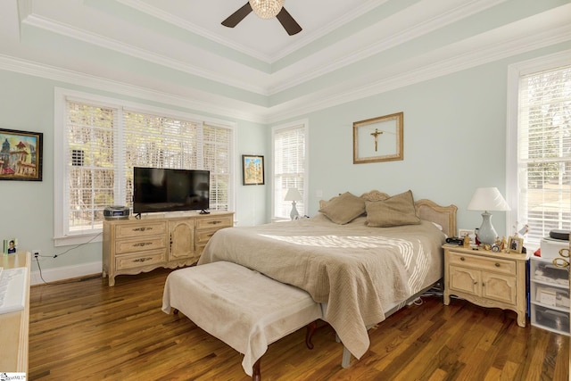 bedroom with ceiling fan, ornamental molding, dark hardwood / wood-style floors, and a raised ceiling