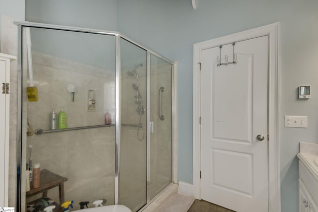 bathroom with tile patterned floors, vanity, and an enclosed shower