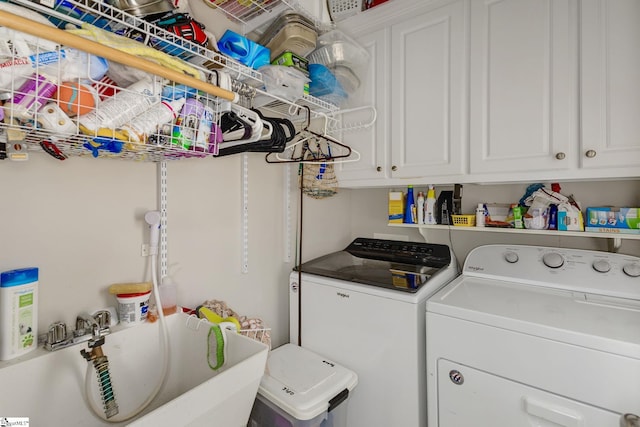 laundry room featuring cabinets, washer and dryer, and sink