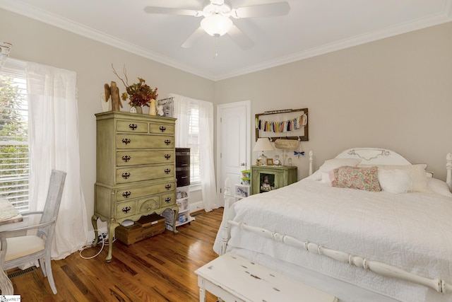 bedroom with ornamental molding, dark hardwood / wood-style floors, and ceiling fan