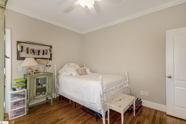 bedroom featuring crown molding, dark wood-type flooring, and ceiling fan