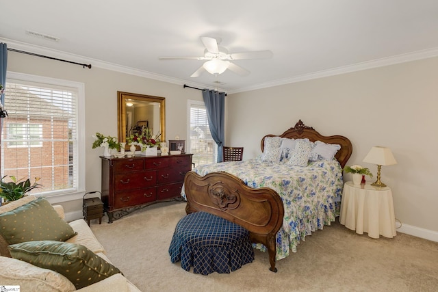 carpeted bedroom with ornamental molding and ceiling fan