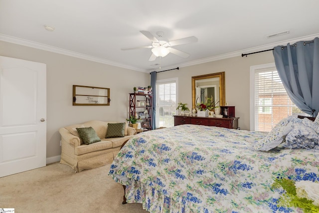 carpeted bedroom with ornamental molding and ceiling fan