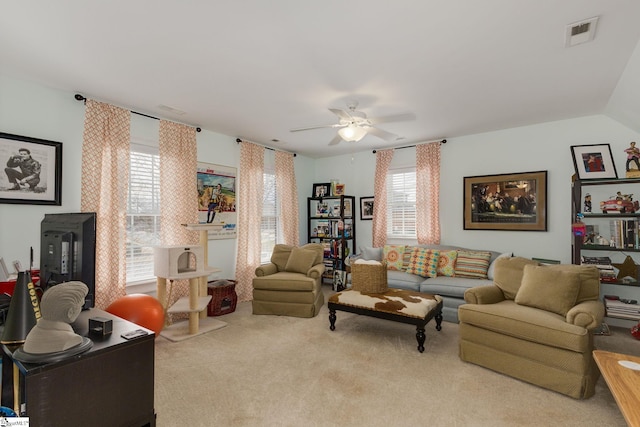 living room with ceiling fan and light carpet