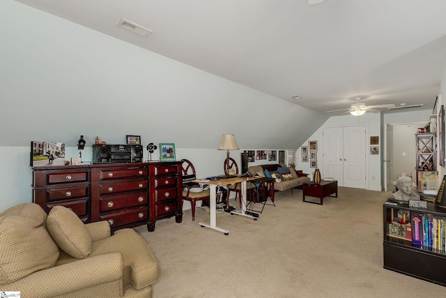 home office featuring vaulted ceiling, light carpet, and ceiling fan