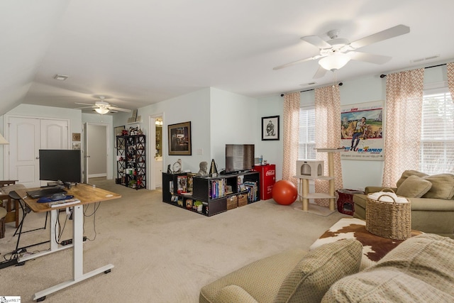 carpeted living room with ceiling fan