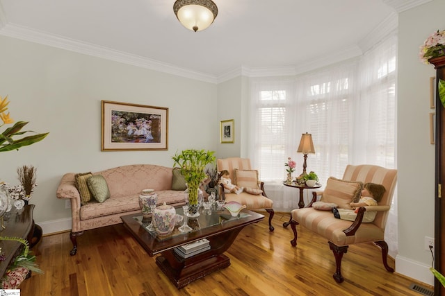 living room featuring hardwood / wood-style flooring and crown molding