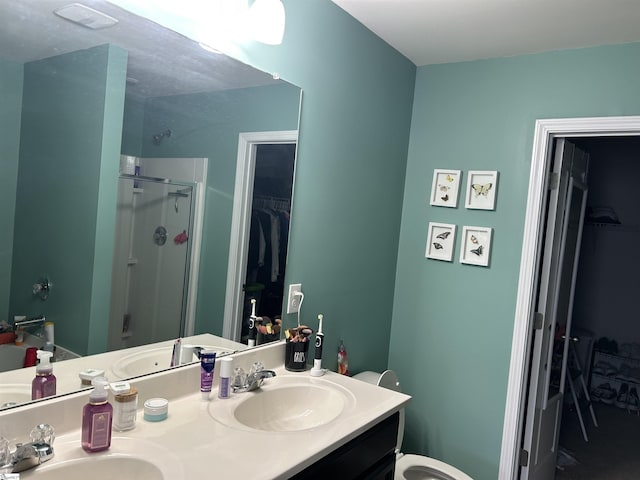 bathroom featuring vanity and a shower with shower door