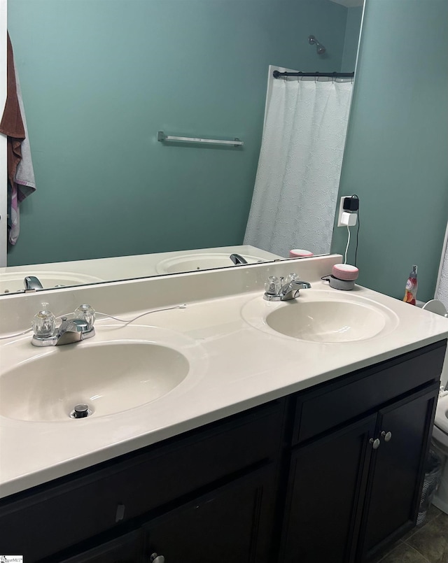 bathroom with tile patterned flooring, vanity, and toilet