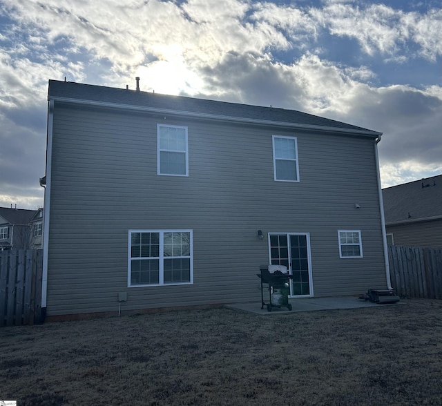 rear view of house with a yard and a patio area