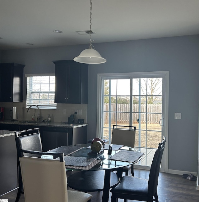 dining area with dark hardwood / wood-style flooring and sink