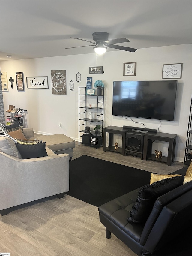 living room with ceiling fan and wood-type flooring