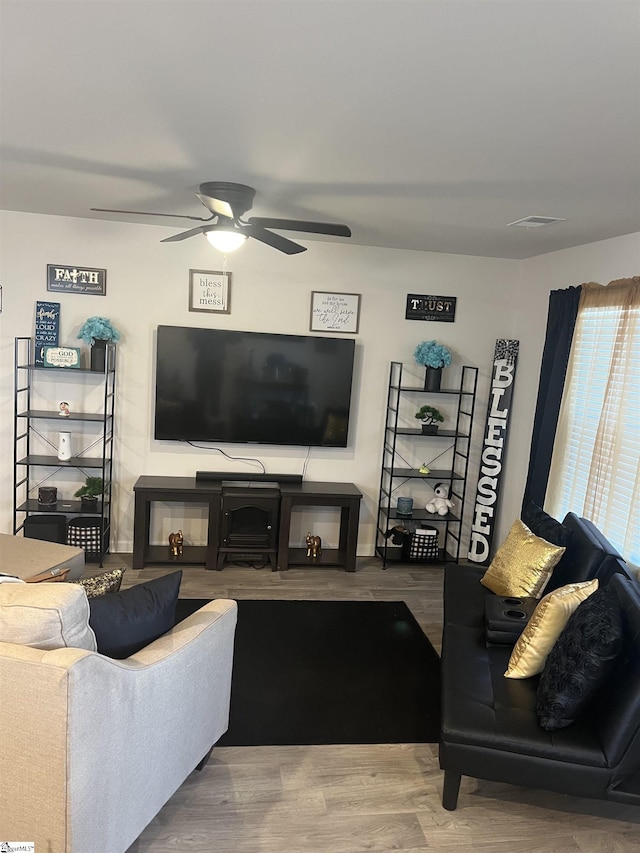 living room with ceiling fan and wood-type flooring