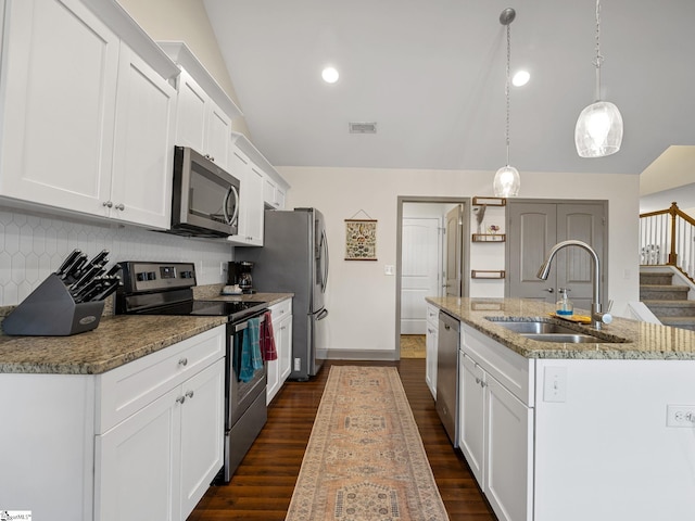 kitchen with white cabinetry, appliances with stainless steel finishes, sink, and decorative light fixtures