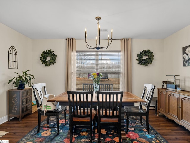 dining room featuring dark wood-type flooring and an inviting chandelier