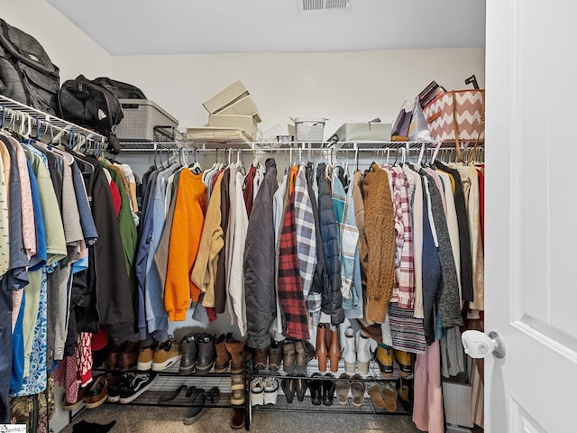 walk in closet with carpet flooring