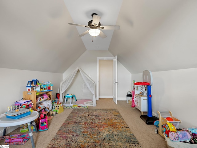 rec room with vaulted ceiling, light colored carpet, and ceiling fan