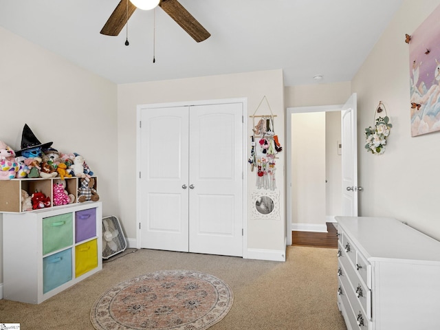 carpeted bedroom with a closet and ceiling fan