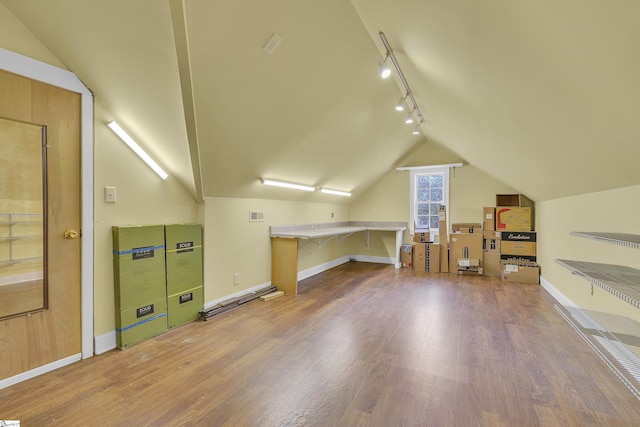 additional living space featuring lofted ceiling and wood-type flooring