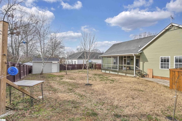 view of yard featuring a storage shed and a sunroom