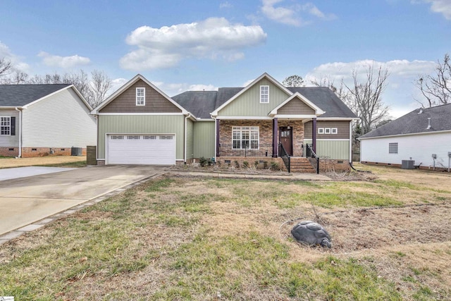 craftsman inspired home with central AC unit, a garage, a front lawn, and a porch