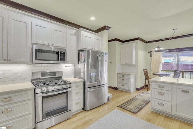 kitchen featuring white cabinetry, tasteful backsplash, stainless steel appliances, and light hardwood / wood-style floors