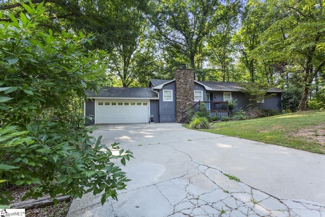 ranch-style house featuring a garage and a front yard