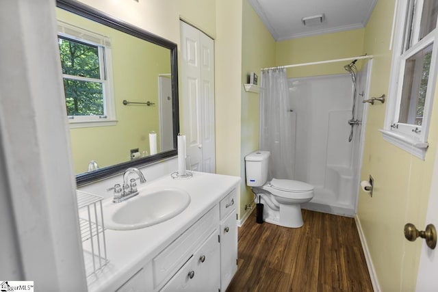 bathroom with curtained shower, hardwood / wood-style flooring, vanity, toilet, and crown molding