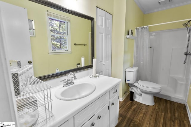 bathroom with toilet, a shower with curtain, ornamental molding, vanity, and hardwood / wood-style flooring