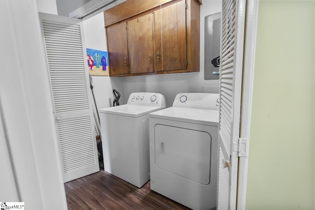 laundry room with dark hardwood / wood-style floors, cabinets, and washing machine and clothes dryer