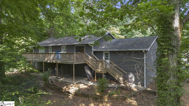 rear view of property with a wooden deck