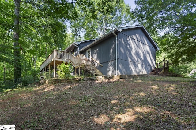 view of property exterior featuring a deck