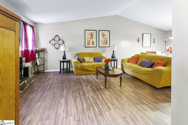 living room with vaulted ceiling and hardwood / wood-style floors